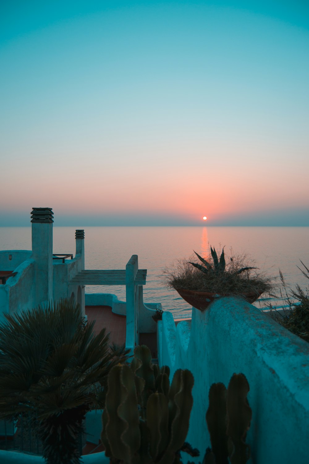 green wooden dock on sea during sunset