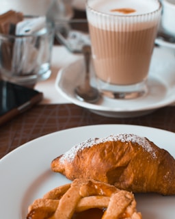 Close-up of a breakfast table set with coffee and pastries.