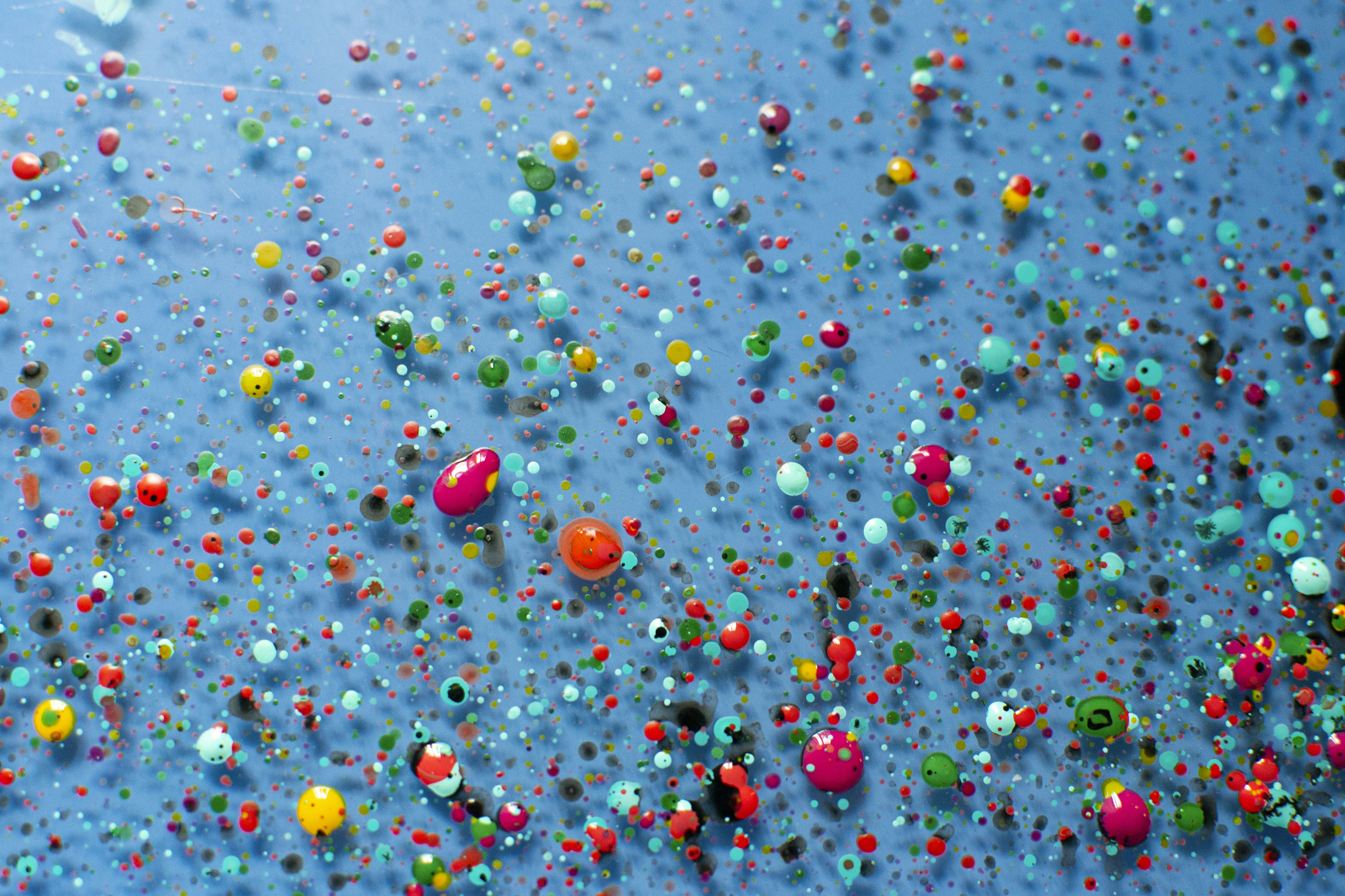 Colorful paint blobs on glass surface
