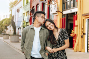 man standing beside woman kissing her head