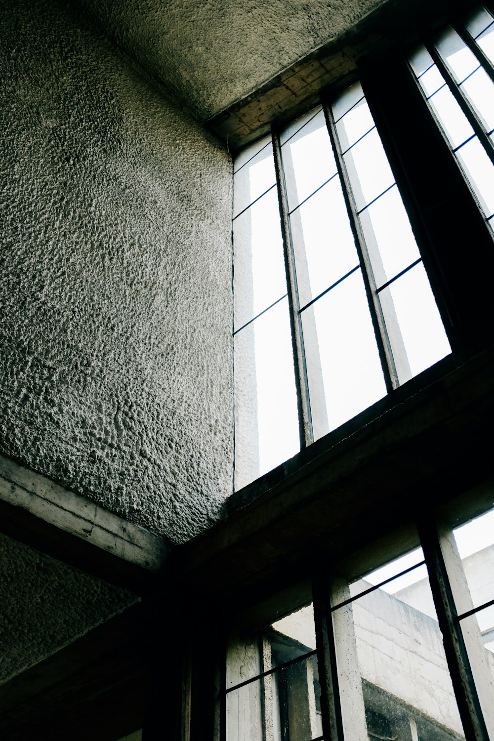 black framed glass window on white concrete wall