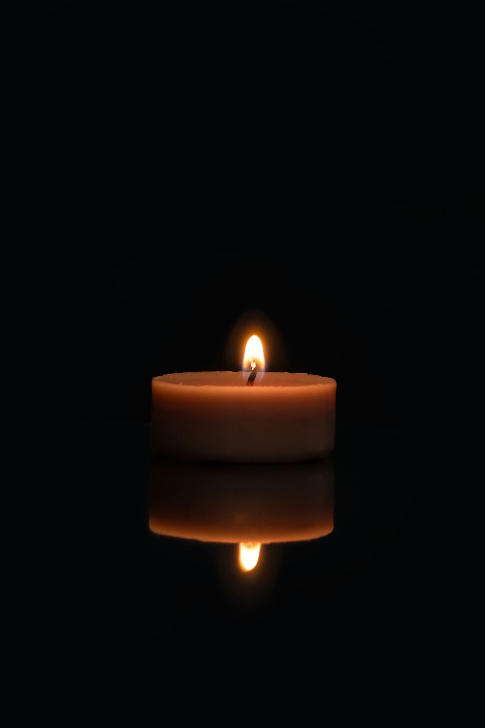 lighted candle in dark room