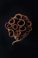 Bundles of aromatic cinnamon sticks stacked in a rustic warehouse.