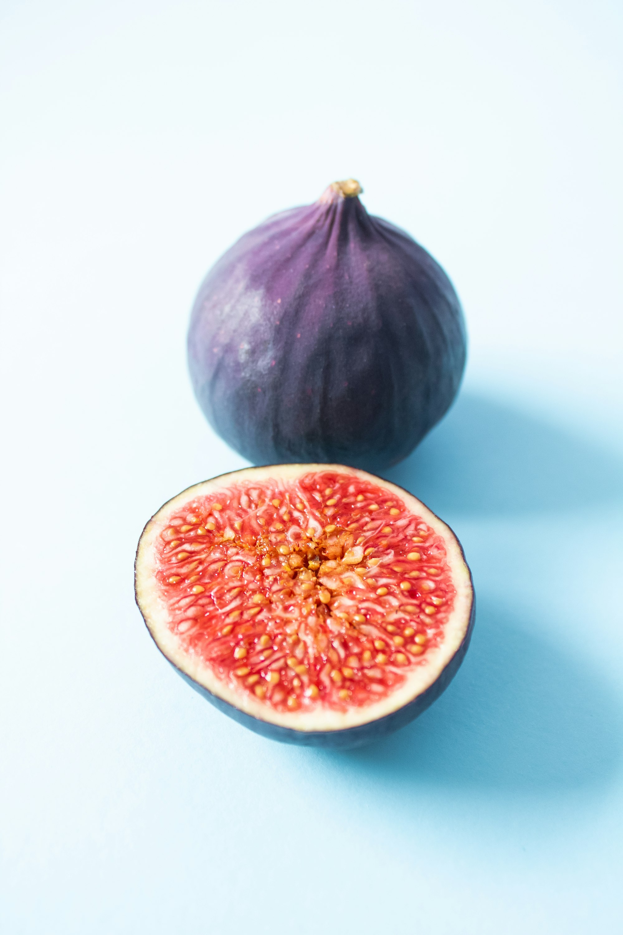 Ripe figs from garden on light blue background