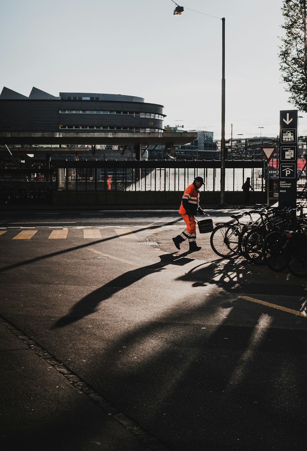 man in red shirt riding bicycle on road during night time