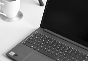black laptop computer on white table