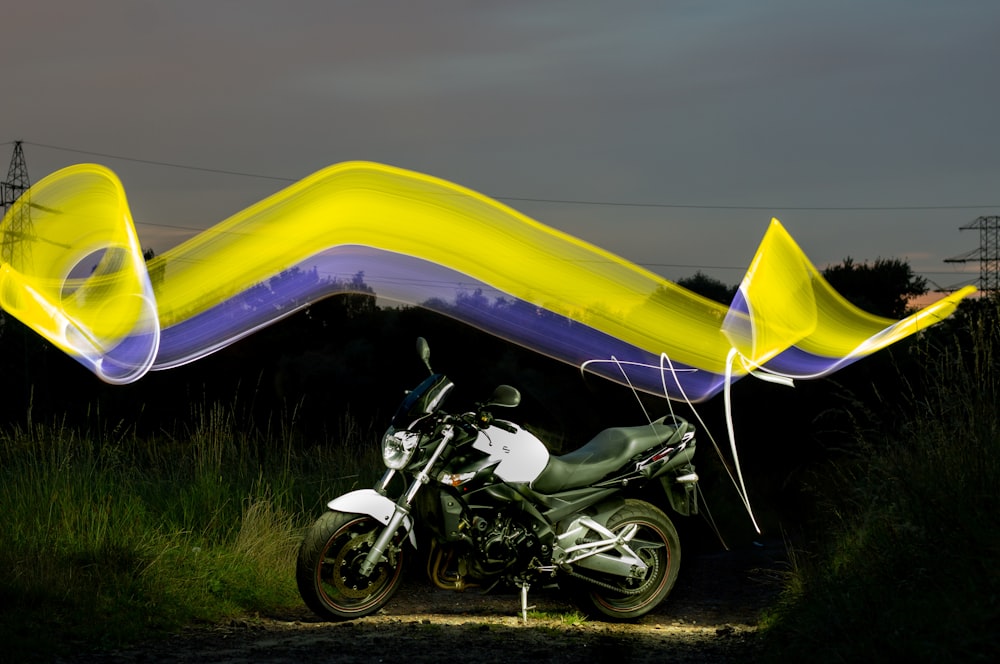 yellow and black motorcycle on green grass field