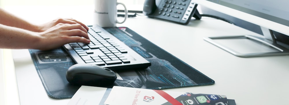 white and gray computer keyboard on white table