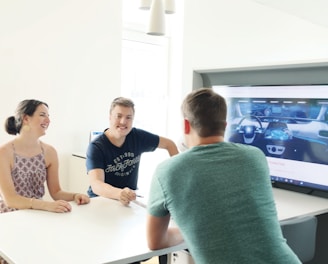 3 men and 2 women sitting at table