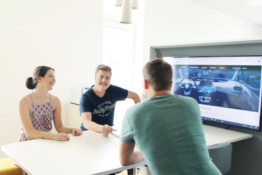 3 men and 2 women sitting at table