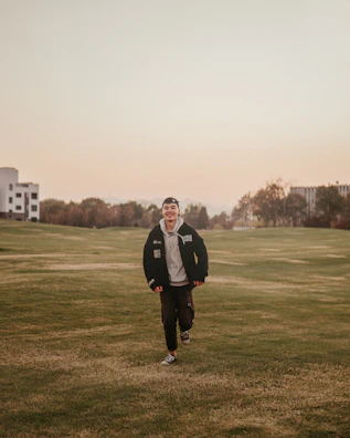 An energetic outdoor run at sunrise with dew on green grass and a clear sky.