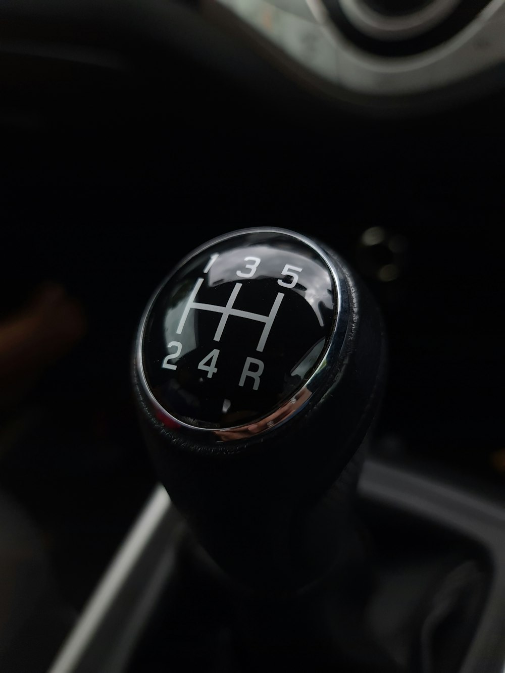 black and silver car gear shift lever