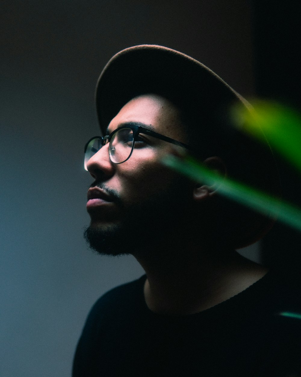 man in black crew neck shirt wearing black framed eyeglasses