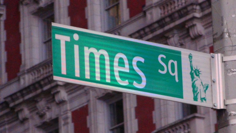 a close up of a street sign with a building in the background