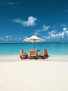 brown wooden chairs on beach during daytime
