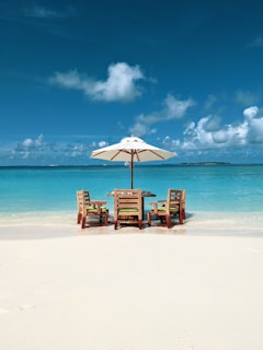 brown wooden chairs on beach during daytime