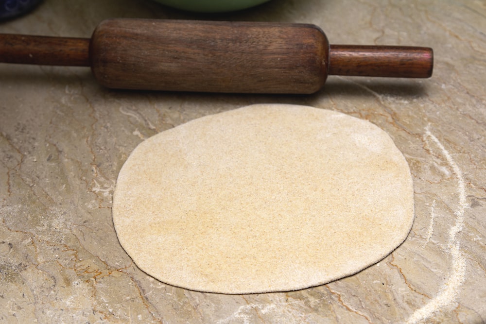 brown wooden rolling pin on brown wooden table