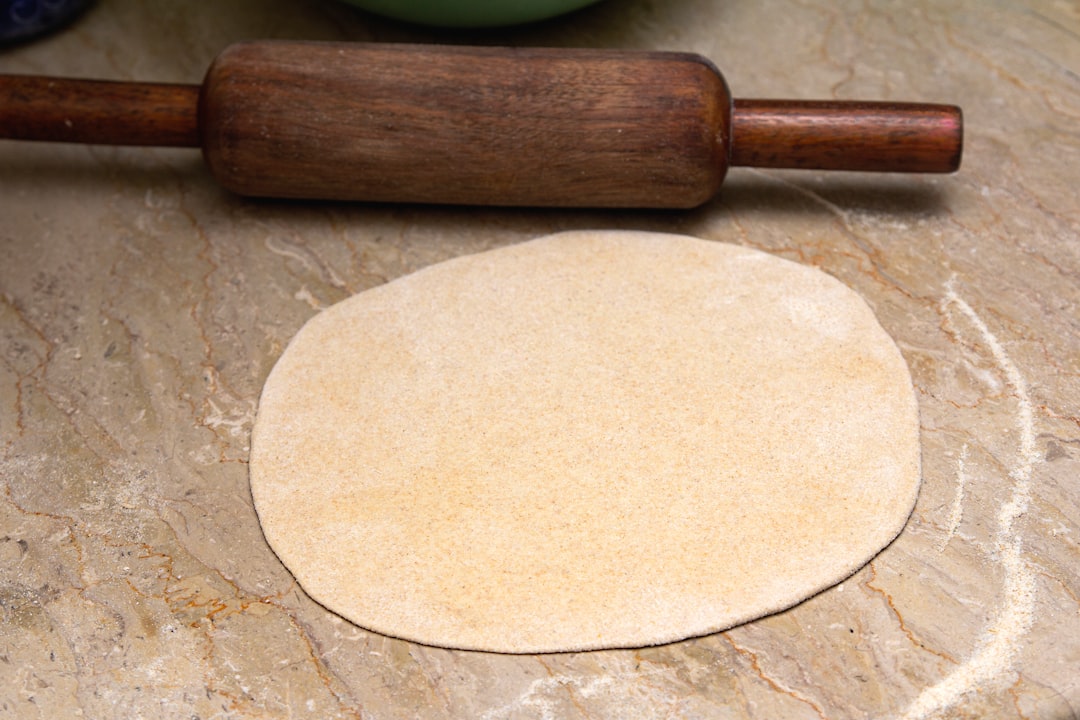 brown wooden rolling pin on brown wooden table