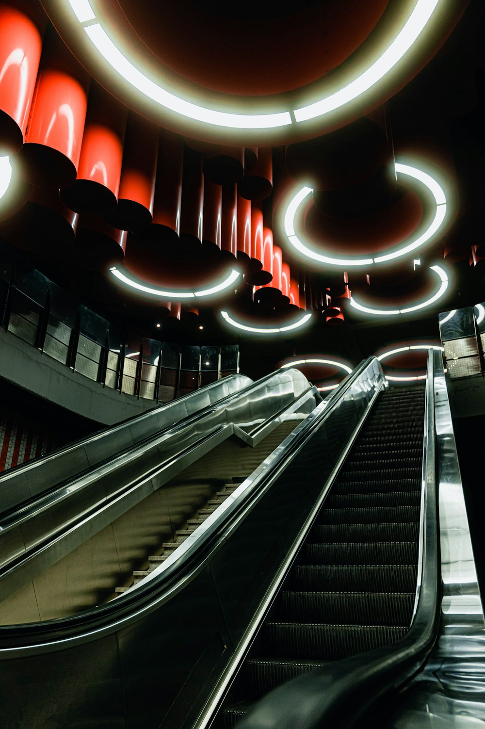 black escalator with red lights