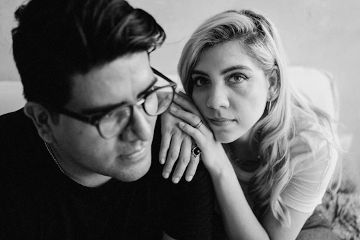 man and woman wearing black crew neck shirt and black framed eyeglasses