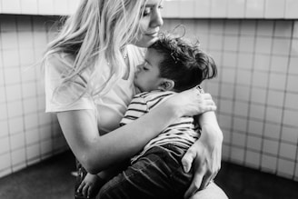 grayscale photo of man and woman kissing