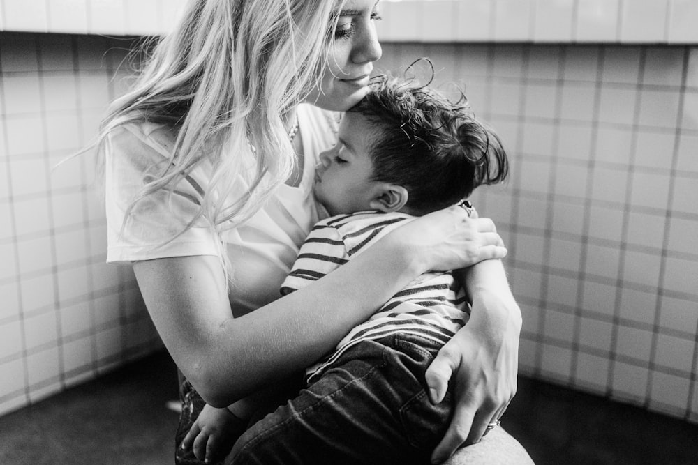 grayscale photo of man and woman kissing