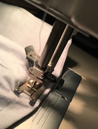 gray metal tool on white textile