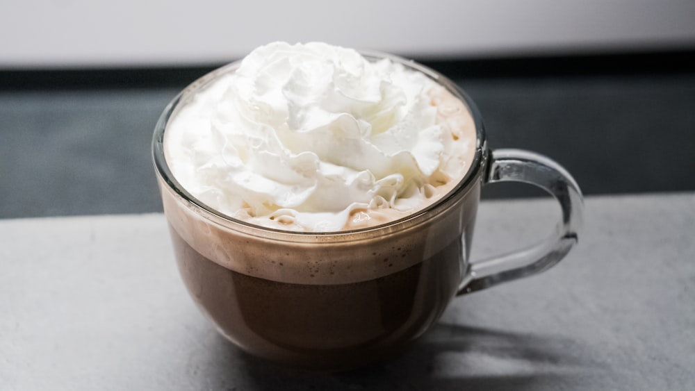 white cream in clear glass mug