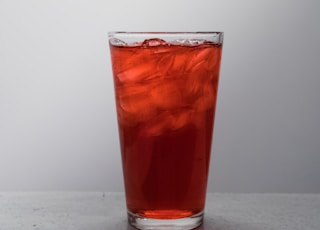 clear drinking glass with brown liquid