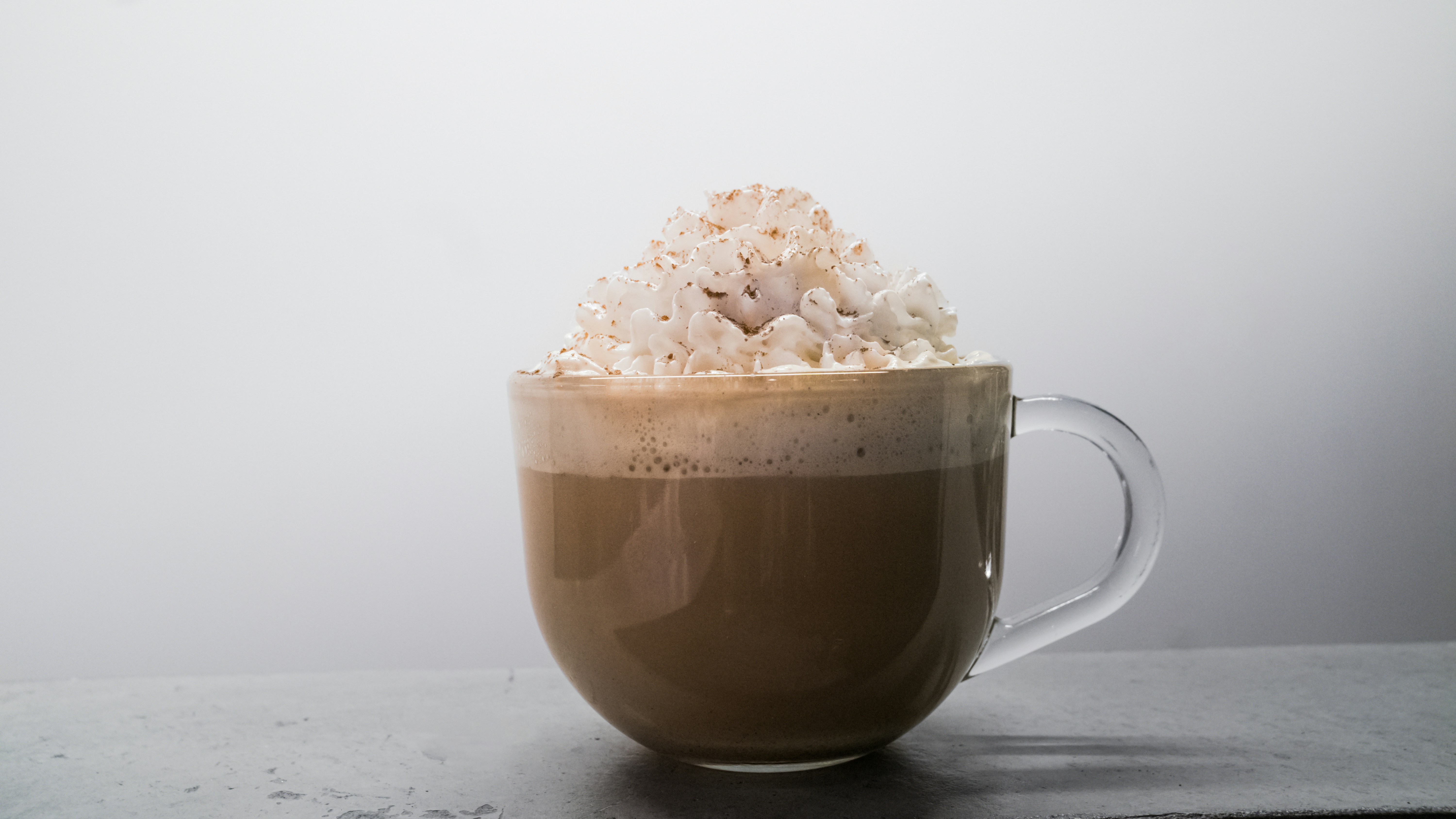 brown ceramic mug with white flower