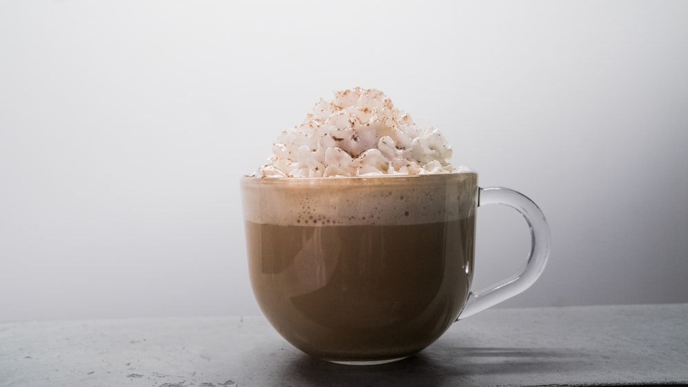 brown ceramic mug with white flower