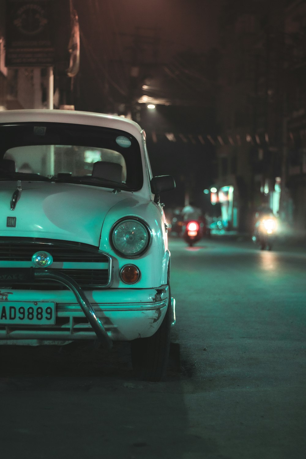 teal volkswagen beetle on road during night time