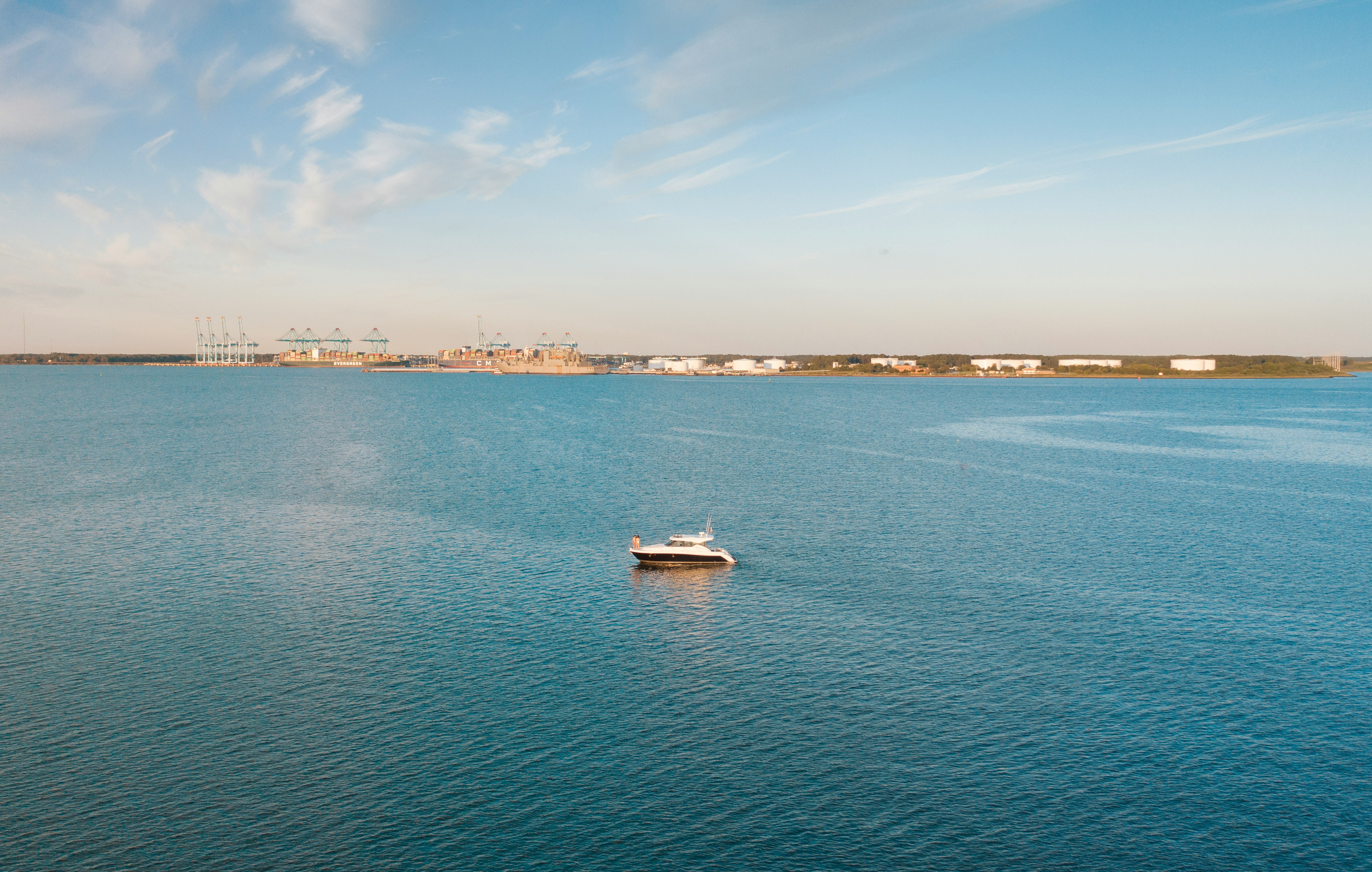 white boat on sea under blue sky during daytime