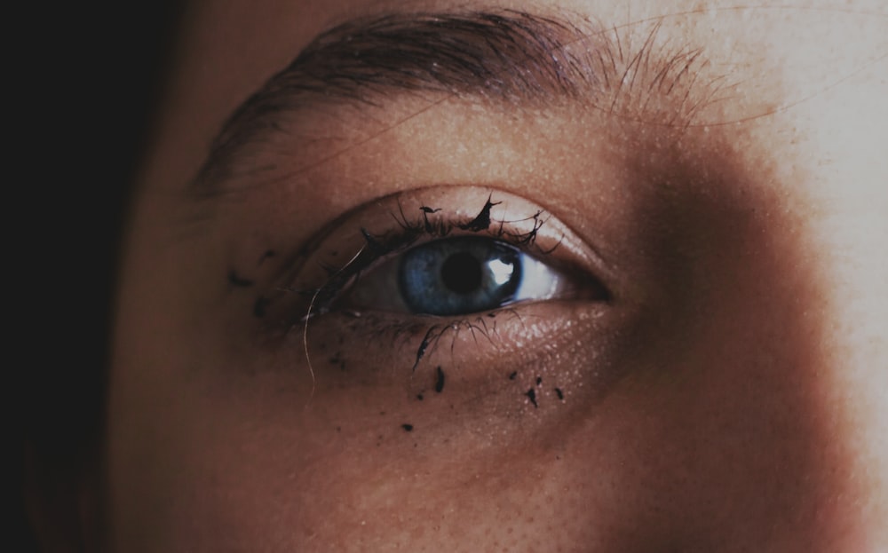 persons blue eyes in close up photography