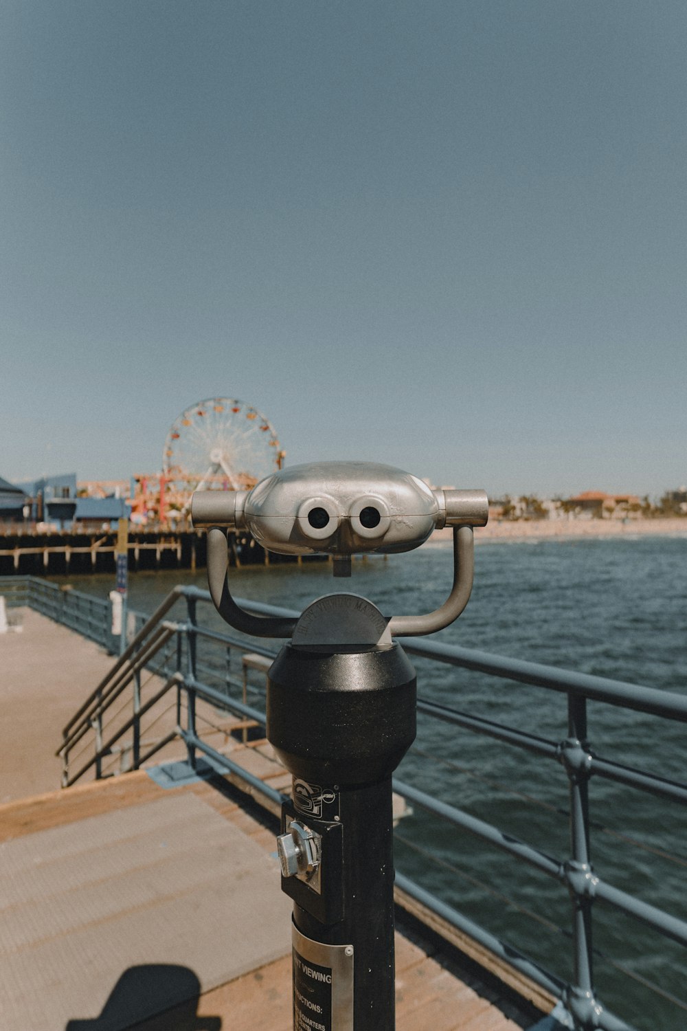 gray and black coin operated telescope on dock during daytime