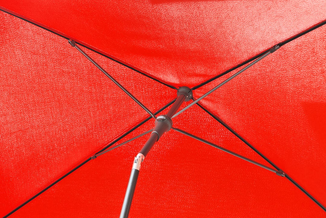 red umbrella with black metal stand