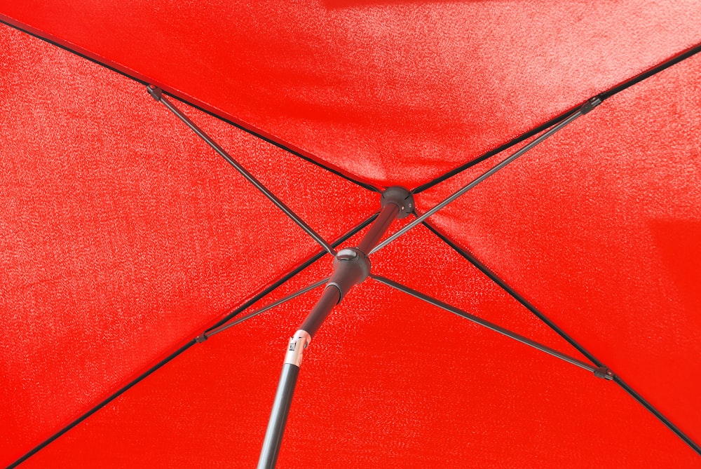 red umbrella with black metal stand