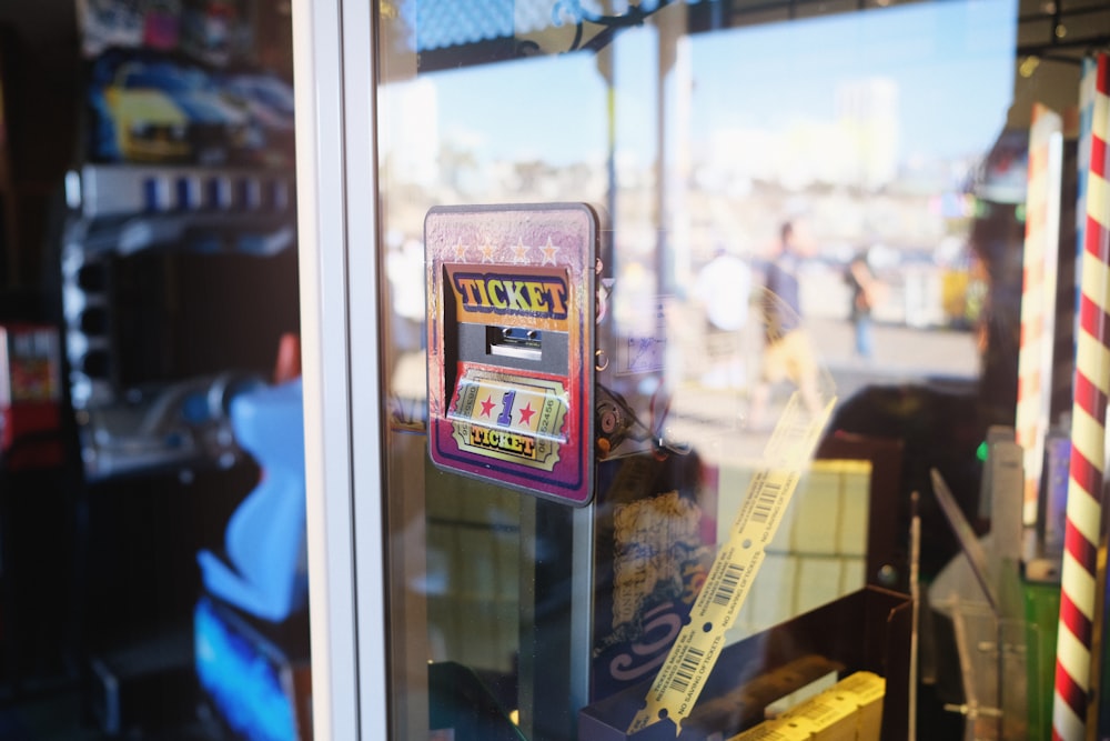 a ticket machine sitting in front of a window