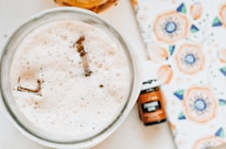 Close-up of artisanal accessories displayed alongside a refreshing beverage glass.