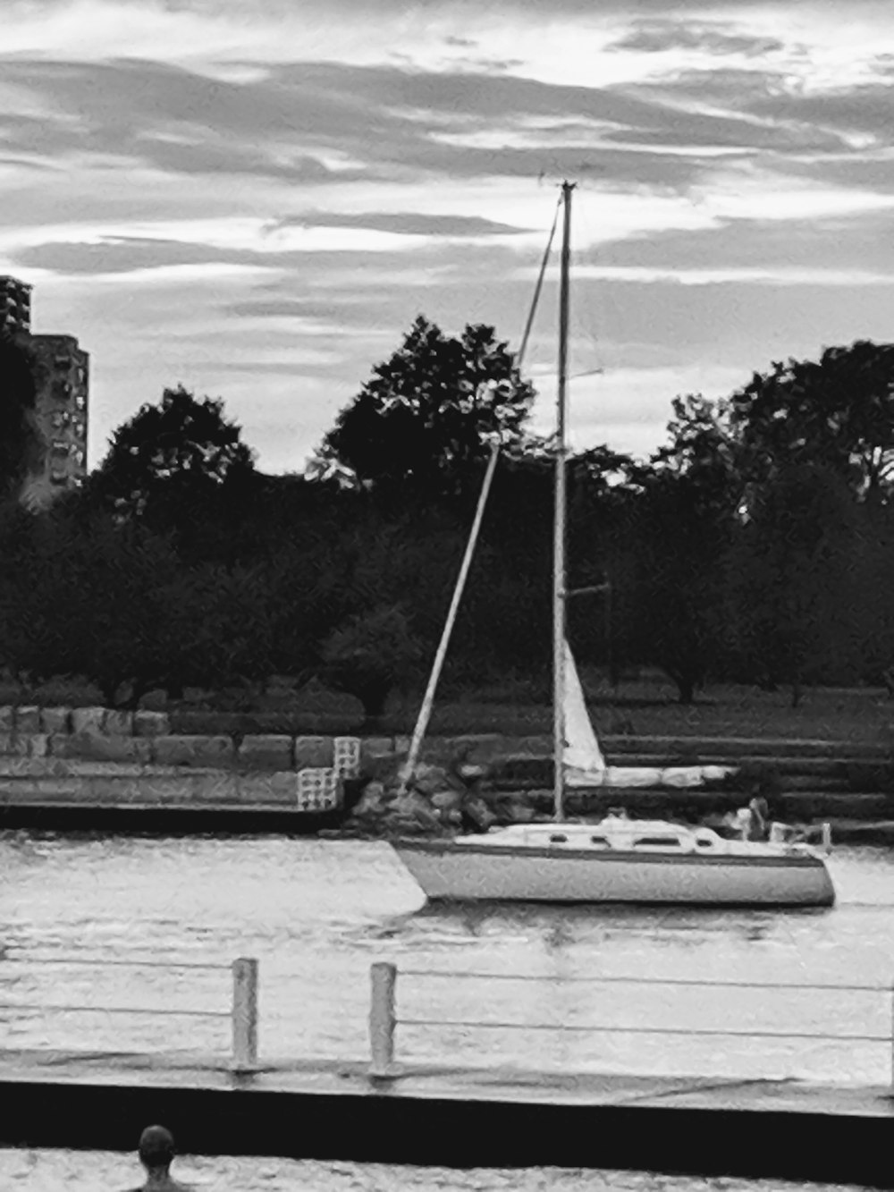 grayscale photo of sailboat on dock