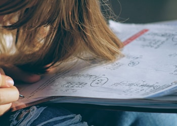 woman in blue denim jacket holding white paper