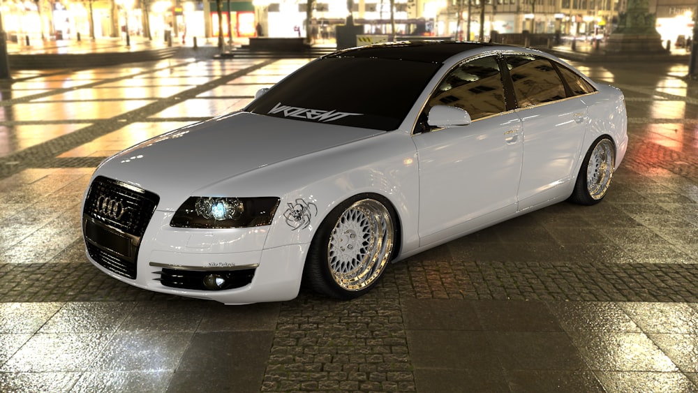 white sedan parked on sidewalk during daytime