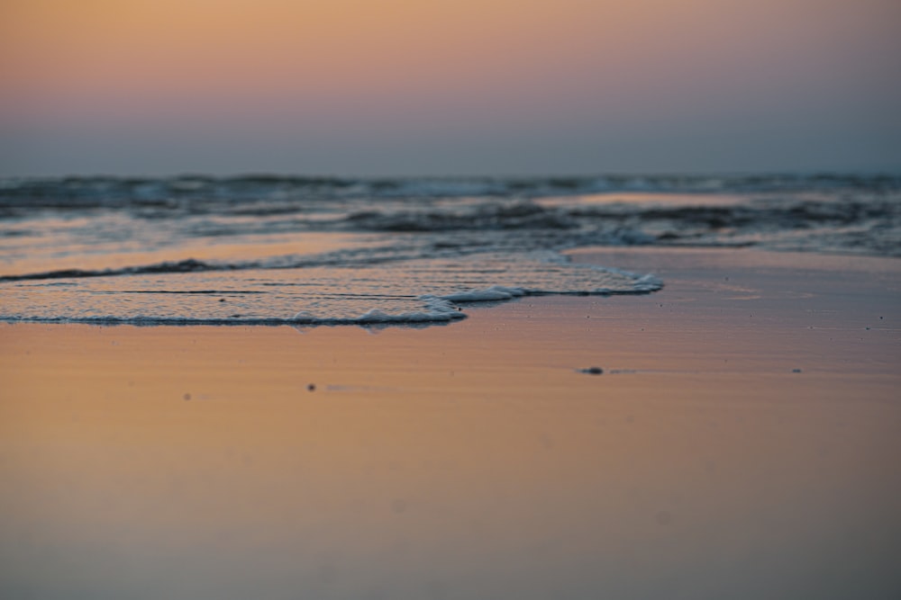 ocean waves crashing on shore during daytime