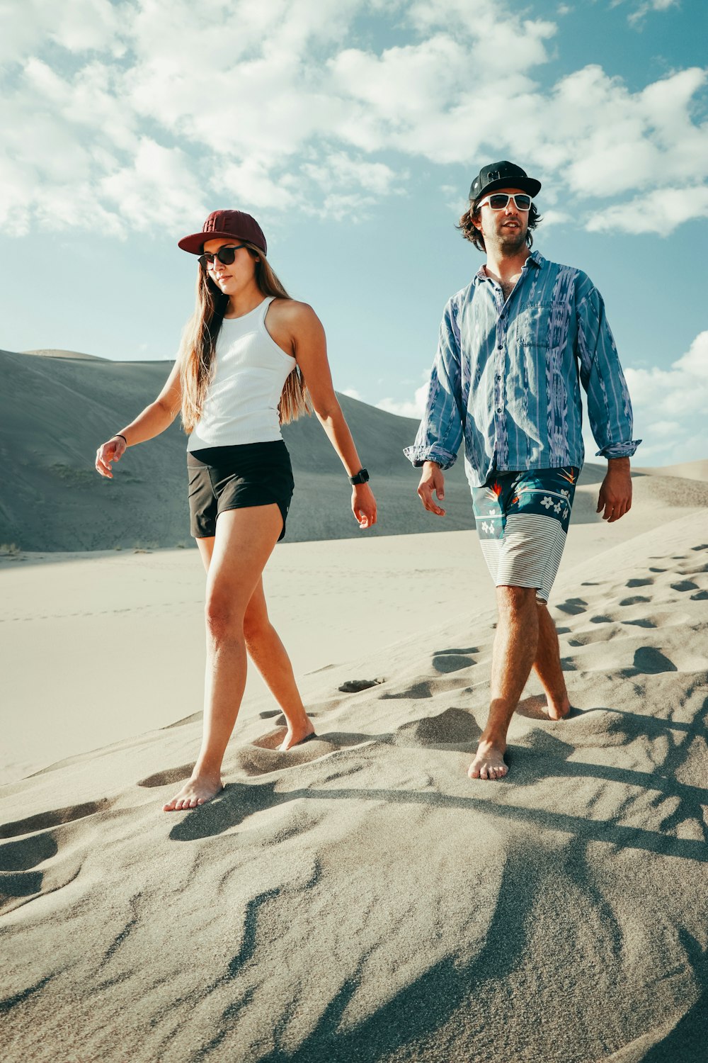 man and woman running on beach during daytime