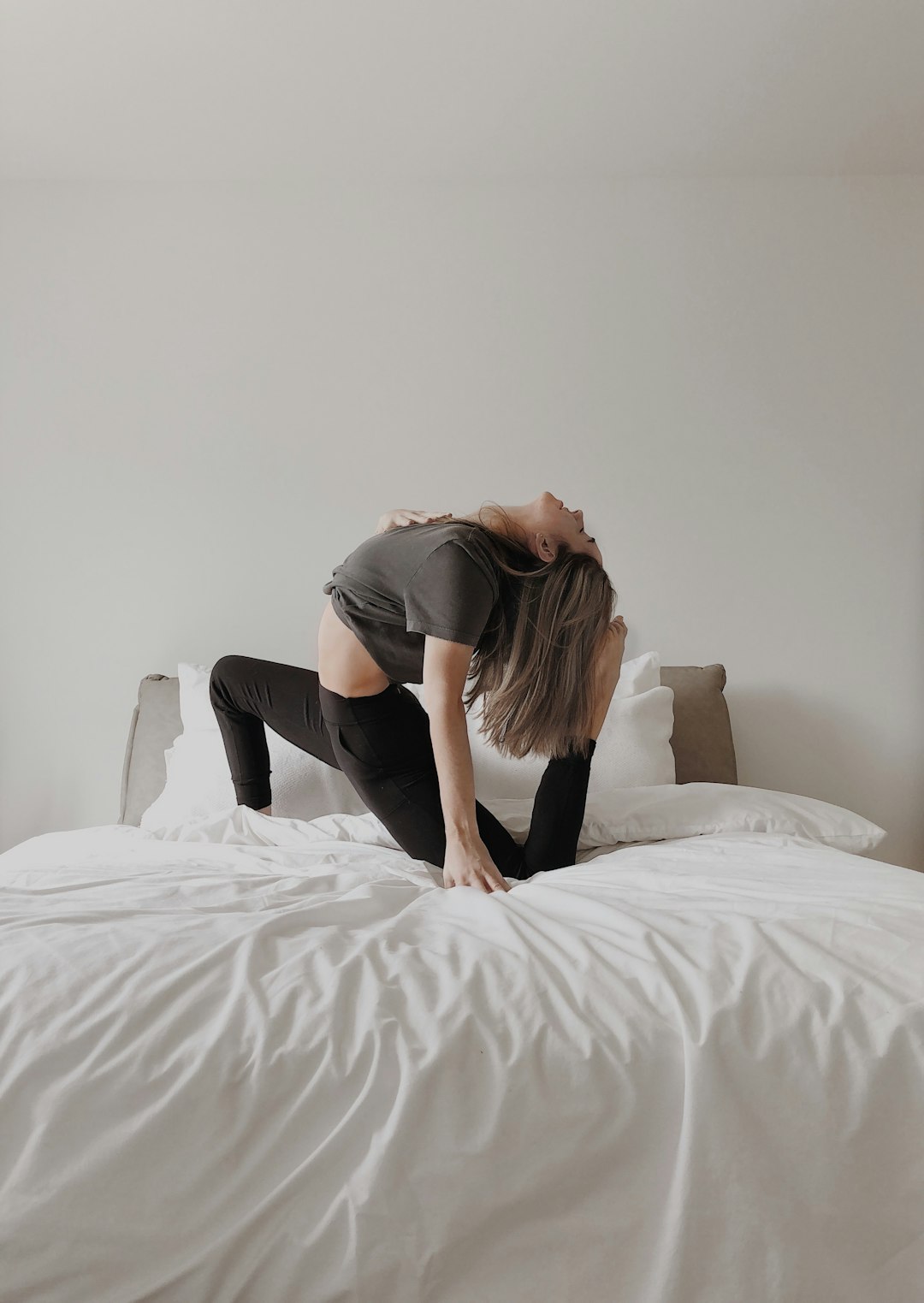 woman in black t-shirt lying on bed