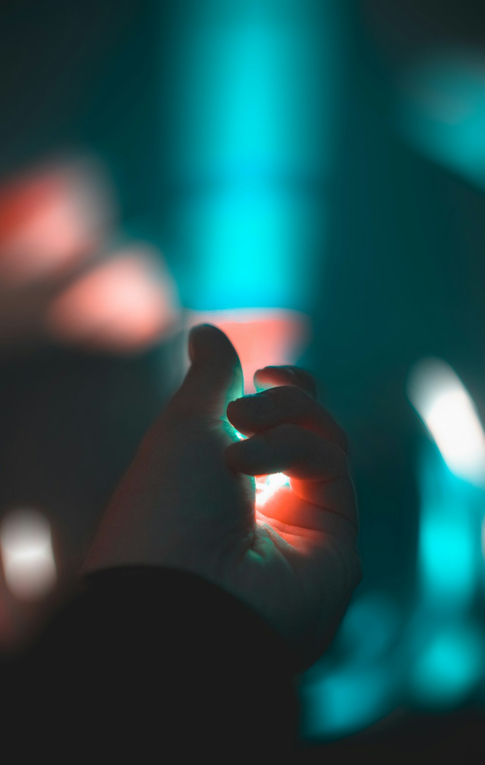 persons left hand with blue light