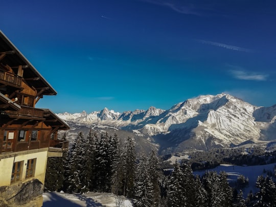 brown wooden house on snow covered ground near snow covered mountain during daytime in Megève France