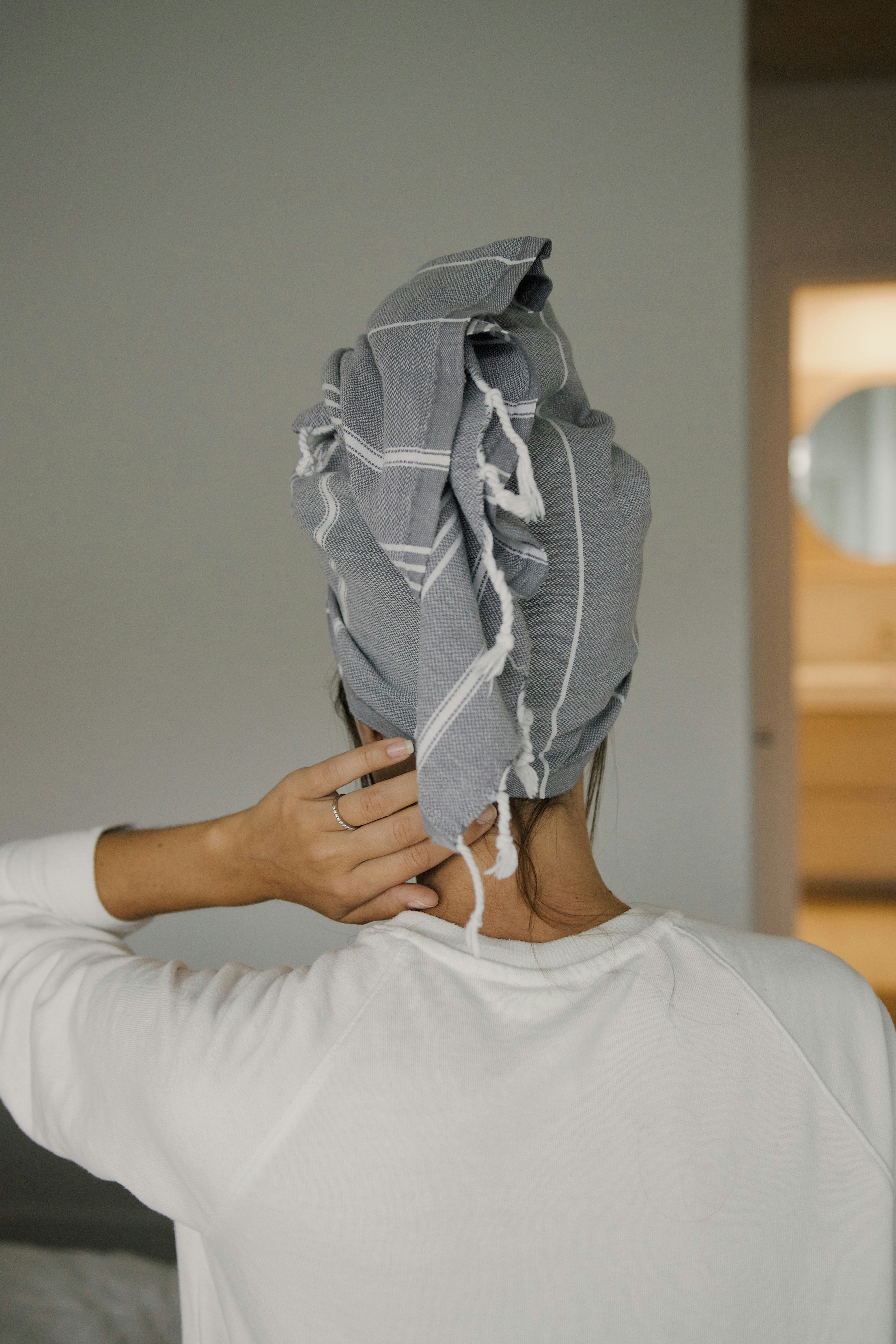 person holding white and gray textile