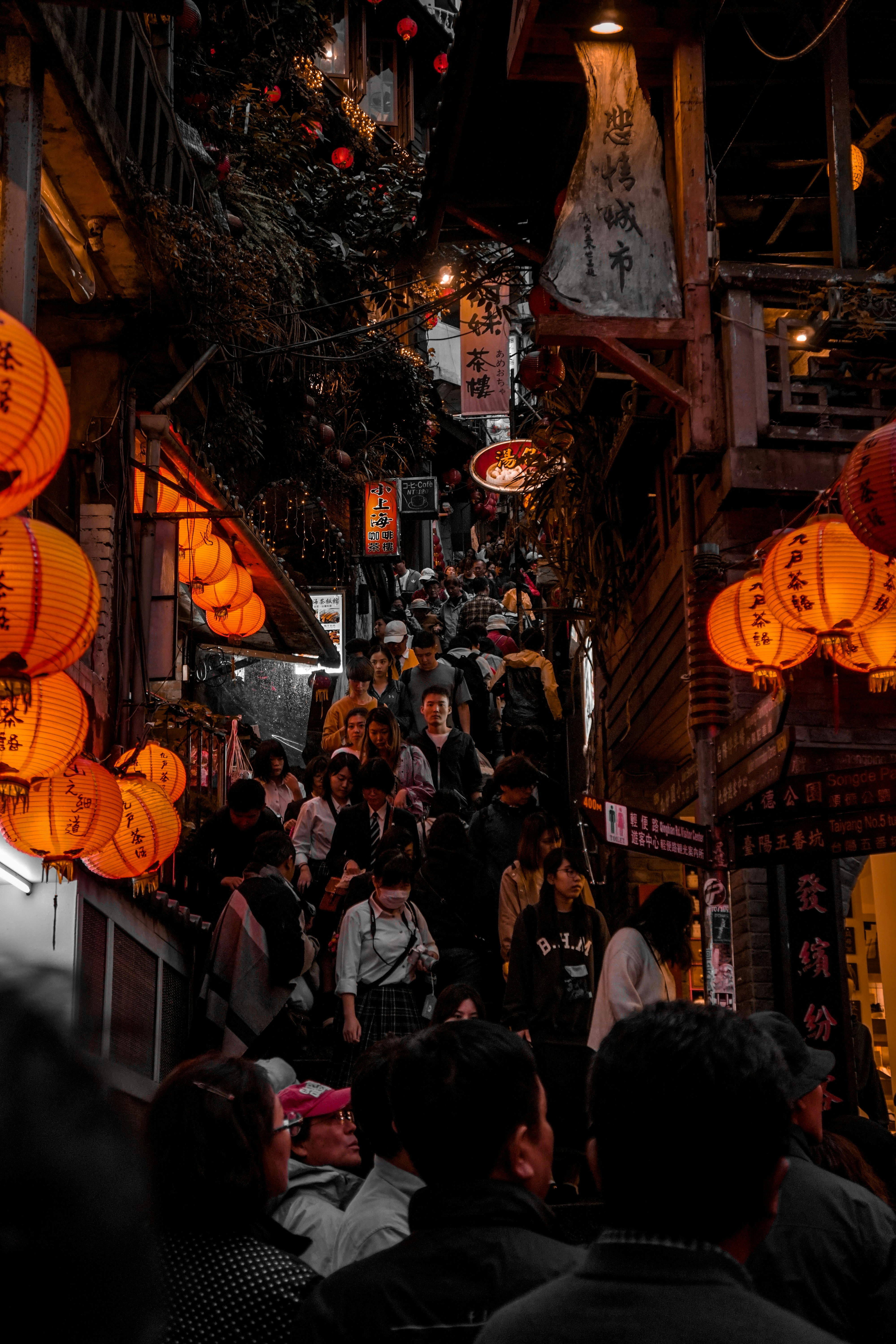 people walking on street during nighttime