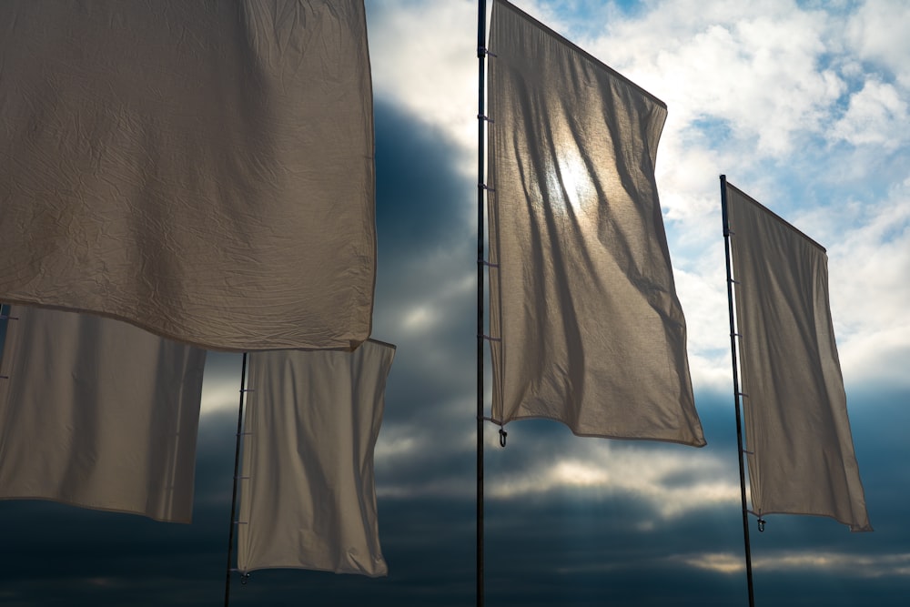 white textile on gray metal pole